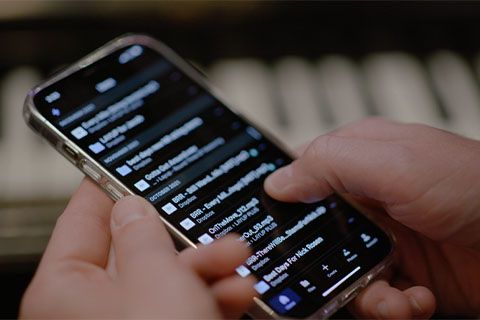 Image of cell phone with Dropbox file list on the screen